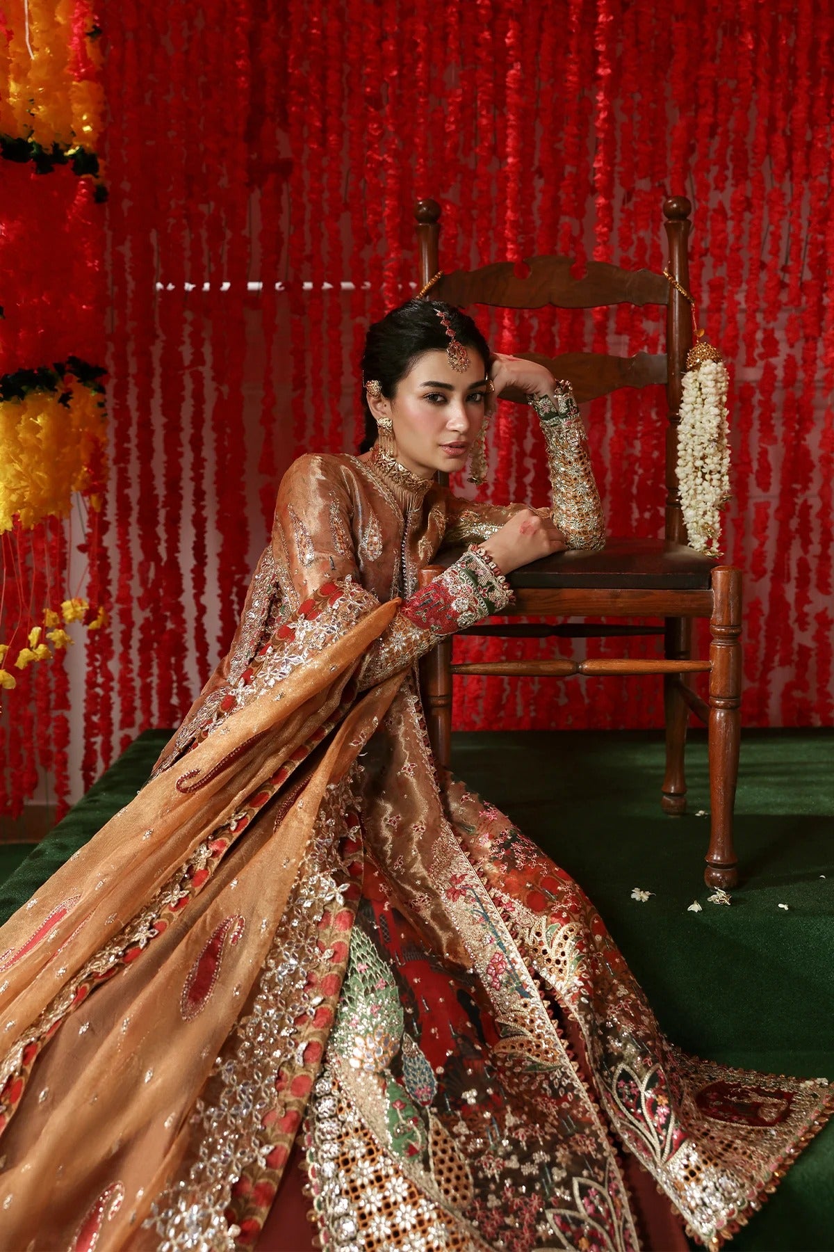 Elegant peach tissue dress with digital prints, zari embroidery, kundan net dupatta, and rust raw silk trouser. A perfect blend of tradition and style.